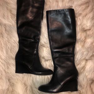 Knee high black heeled boots